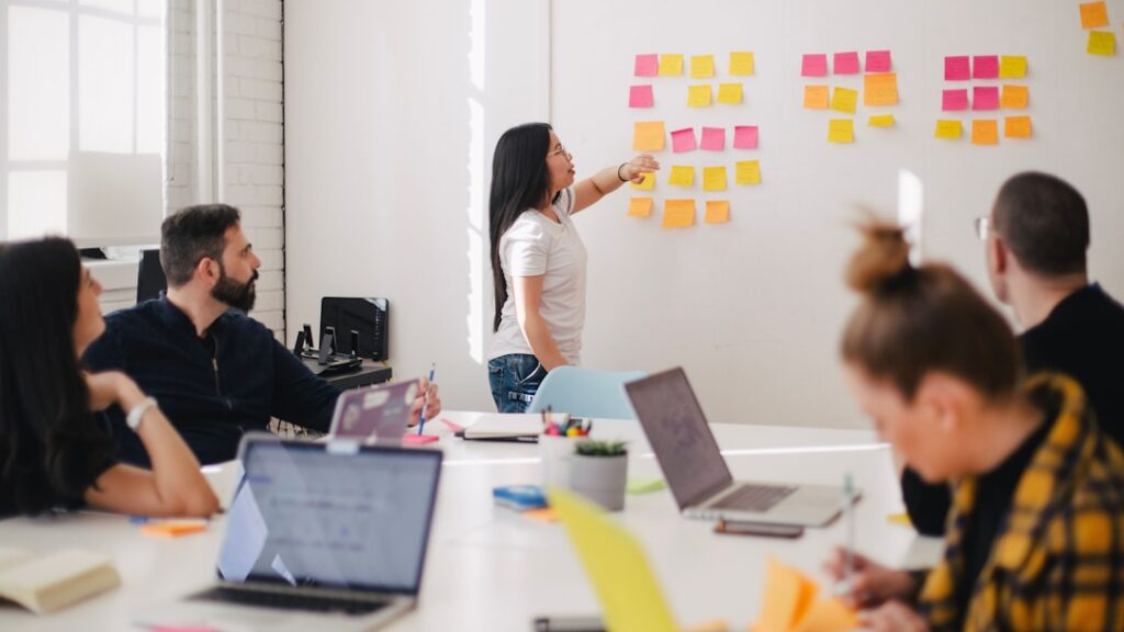 woman placing sticky notes on wall